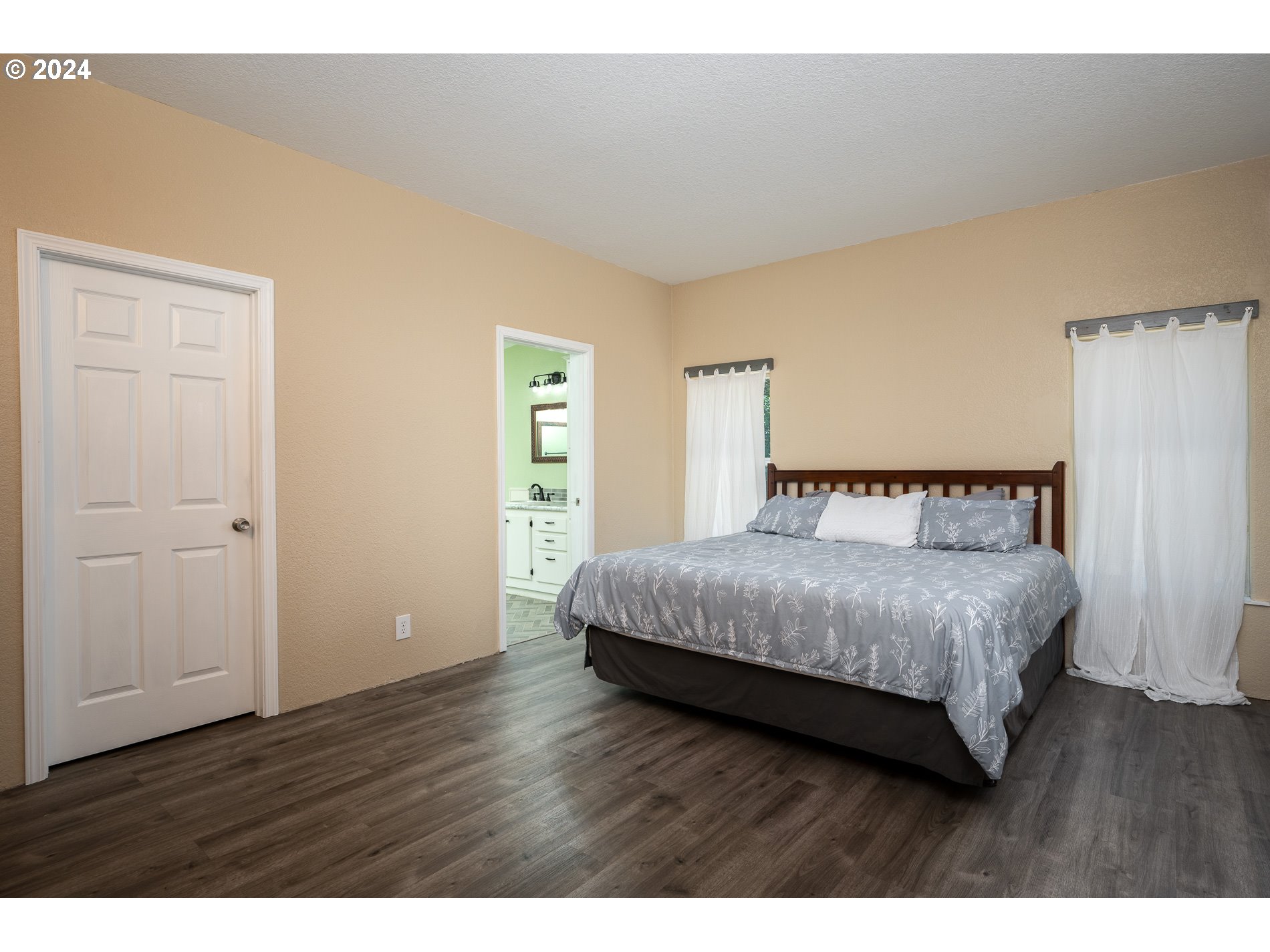 6007 Northeast Lessard Road Camas, WA 98607 - Photo 24 of 48 a bedroom with a bed and wooden floor