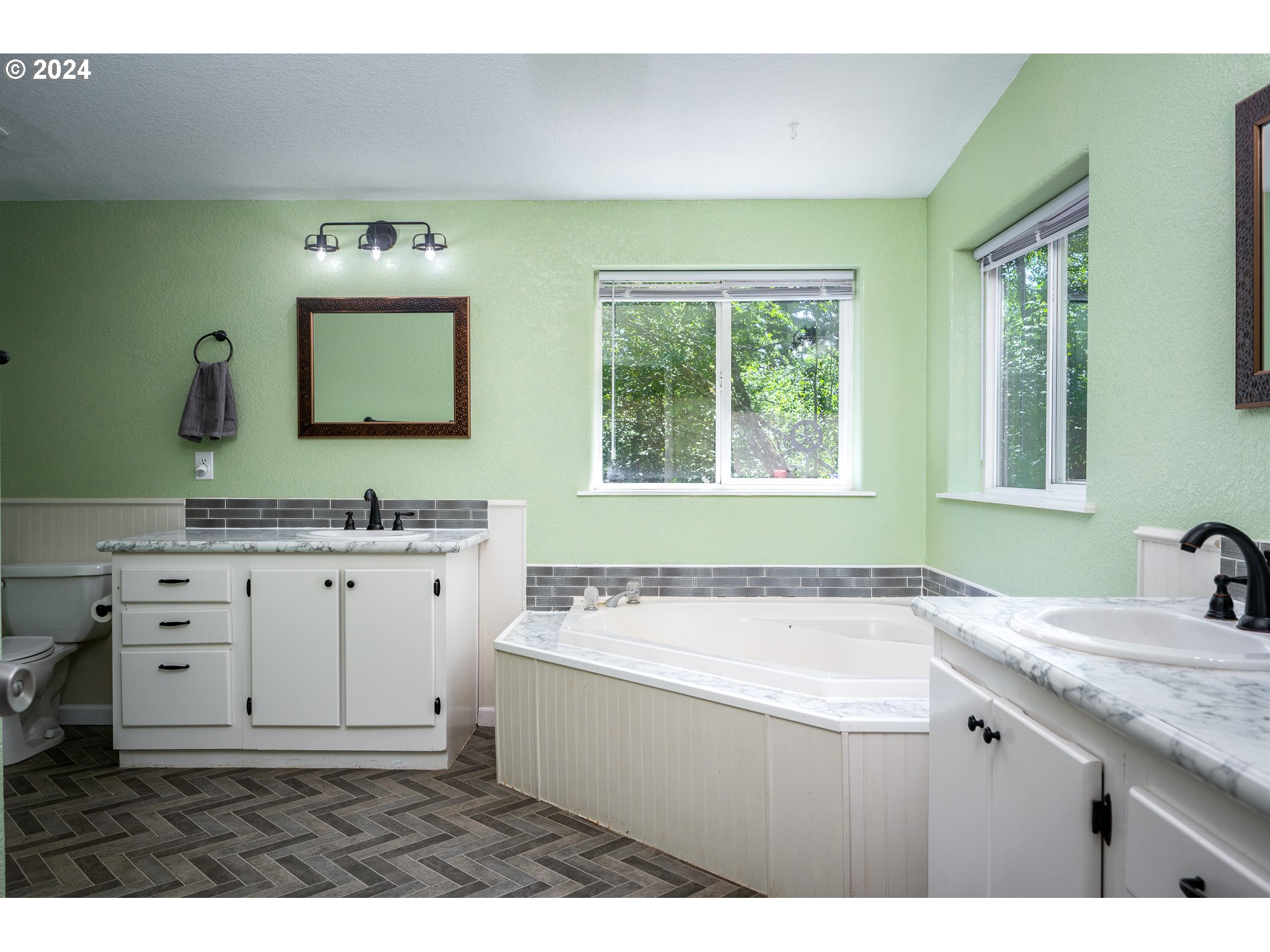 6007 Northeast Lessard Road Camas, WA 98607 - Photo 25 of 48 a bathroom with a granite countertop sink mirror vanity bathtub and next to a window