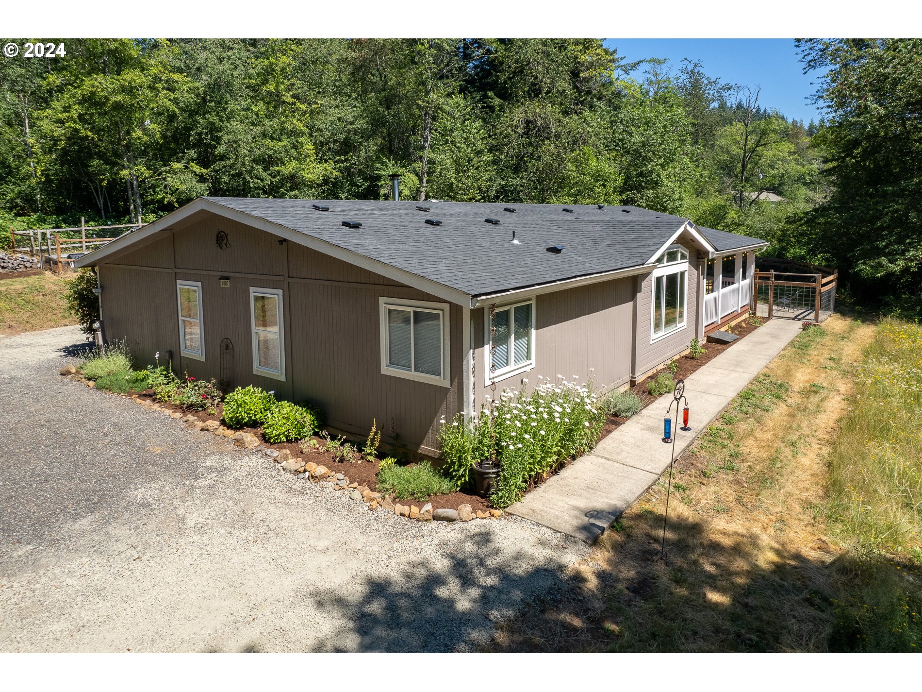 6007 Northeast Lessard Road Camas, WA 98607 - Photo 5 of 48 a aerial view of a house with a yard and large trees