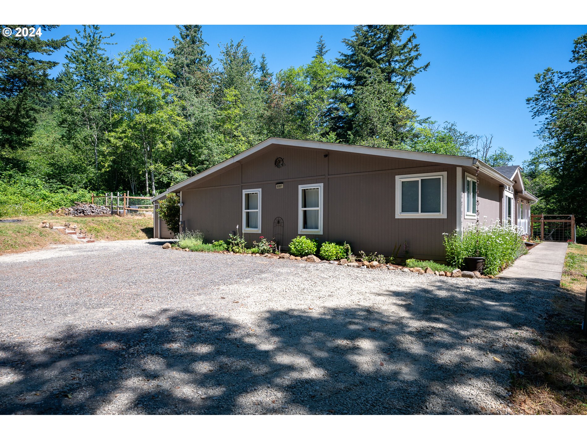 6007 Northeast Lessard Road Camas, WA 98607 - Photo 7 of 48 a front view of house with yard and trees in the background