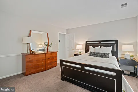 a bedroom with a bed and lamp