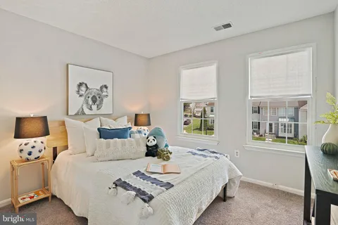 a bedroom with bed and a window