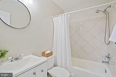 a bathroom with a sink vanity mirror and toilet