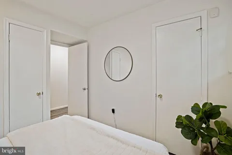 a bedroom with a bed and a potted plant