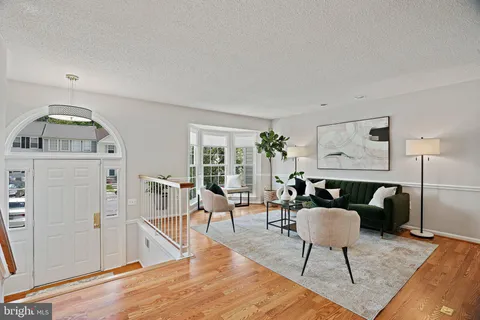 a living room with furniture a rug and a chandelier