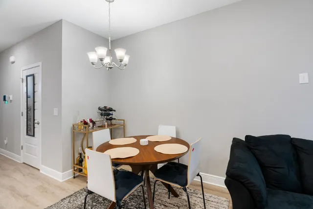 a view of a dining room with furniture and chandelier