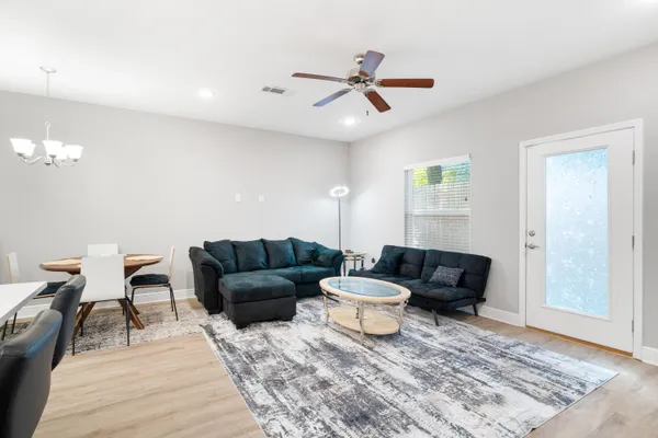 a living room with furniture and a rug