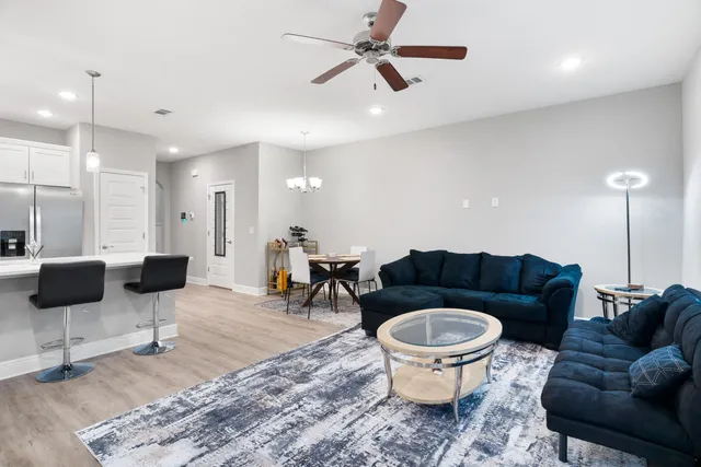 a living room with furniture a rug and a chandelier