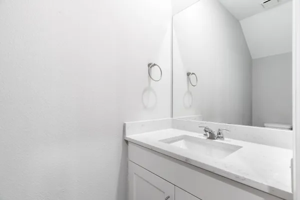 a bathroom with a sink and mirror