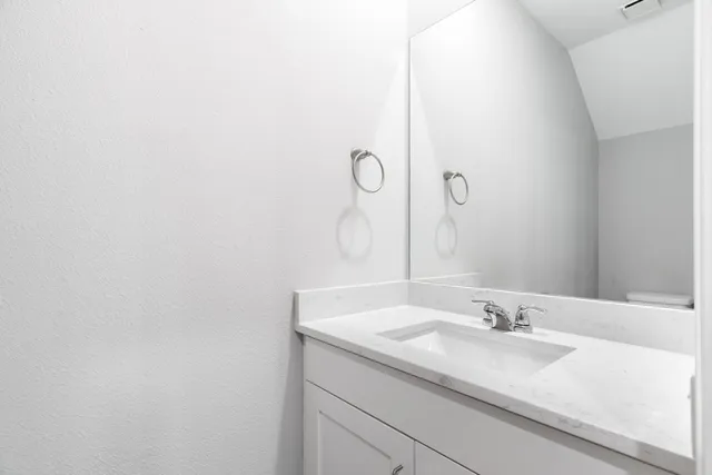 a bathroom with a sink and mirror