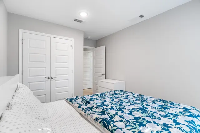 a bedroom with a bed and with cabinets