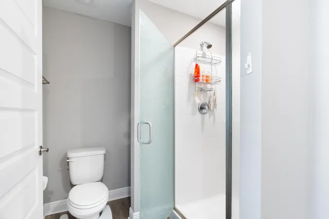 a bathroom with a toilet and a shower