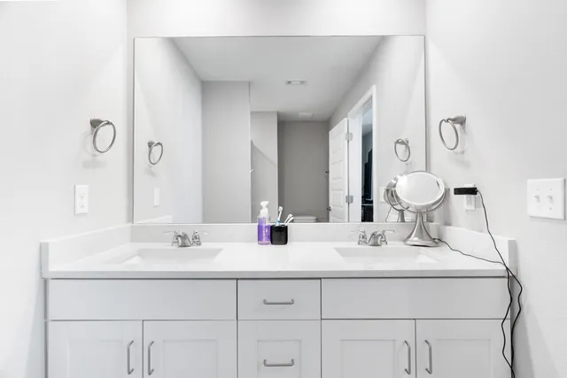 a bathroom with a sink vanity and a mirror