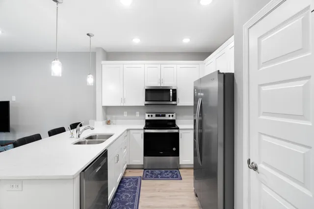 a kitchen with a sink appliances and cabinets