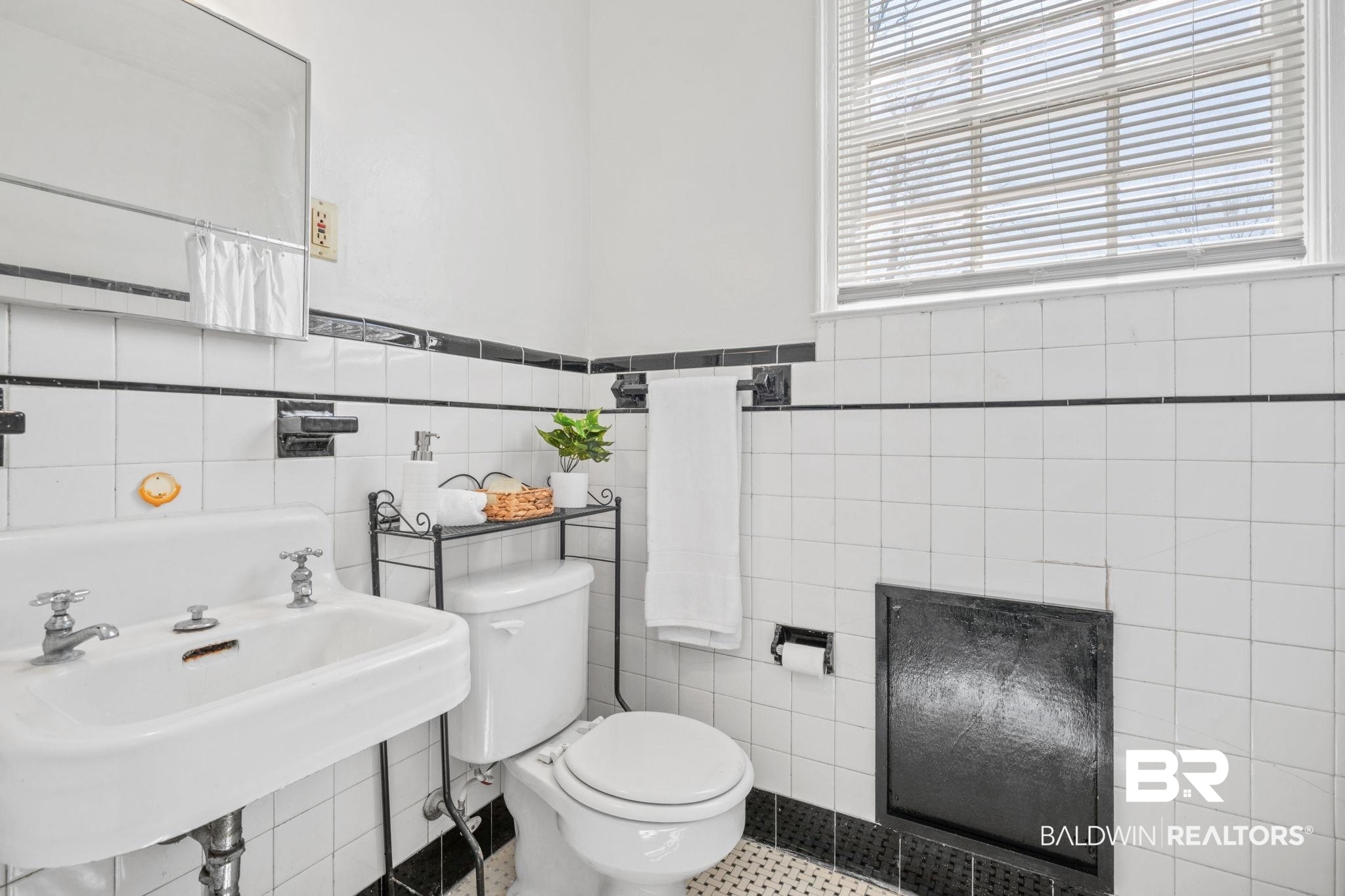 1707 Church Street Mobile, AL 36604 - Photo 16 of 43 Bathroom with a sink, a wainscoted wall, toilet, and tile walls