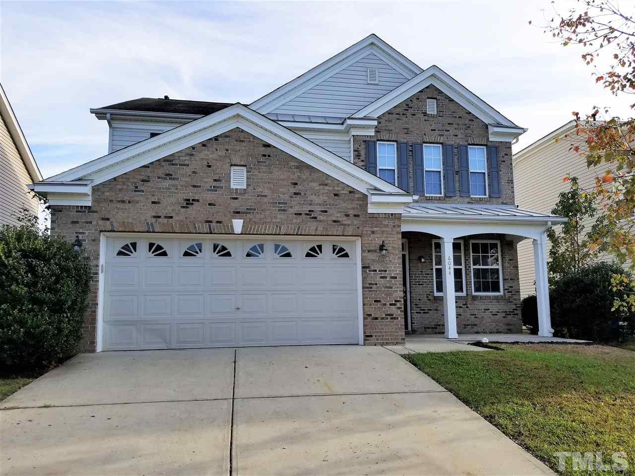 6044 Ricker Road Raleigh, NC 27610 - Photo 1 of 14 front view of a house with a yard