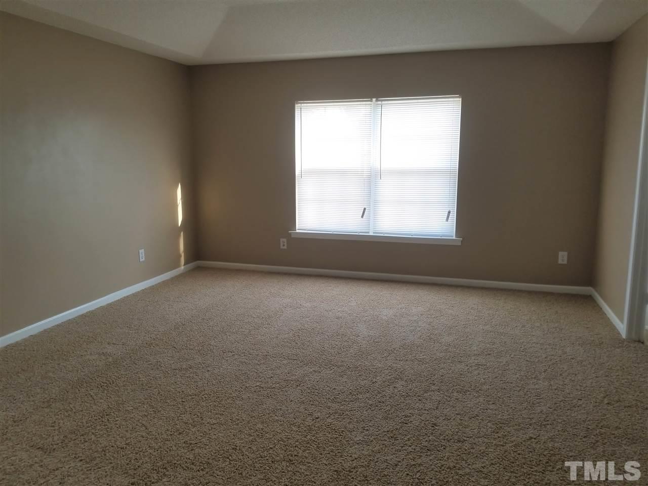 6044 Ricker Road Raleigh, NC 27610 - Photo 11 of 14 an empty room with a window