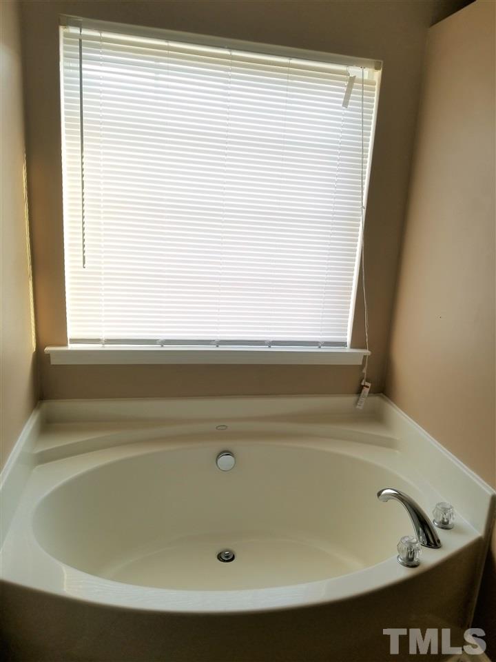 6044 Ricker Road Raleigh, NC 27610 - Photo 12 of 14 a bathroom with a bathtub