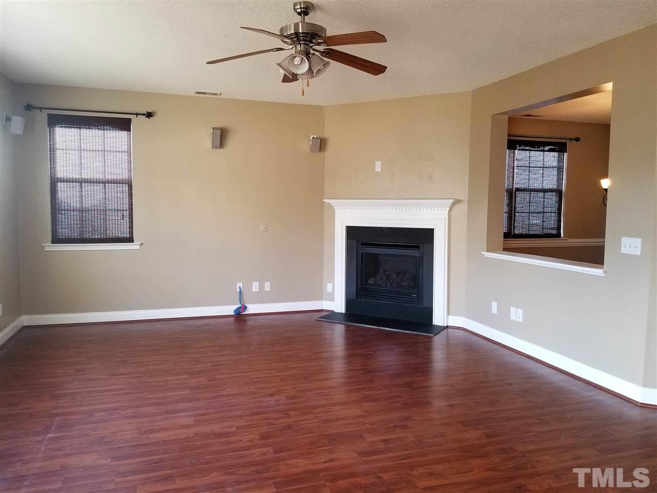 6044 Ricker Road Raleigh, NC 27610 - Photo 3 of 14 a view of an empty room with exposed radiator and fireplace