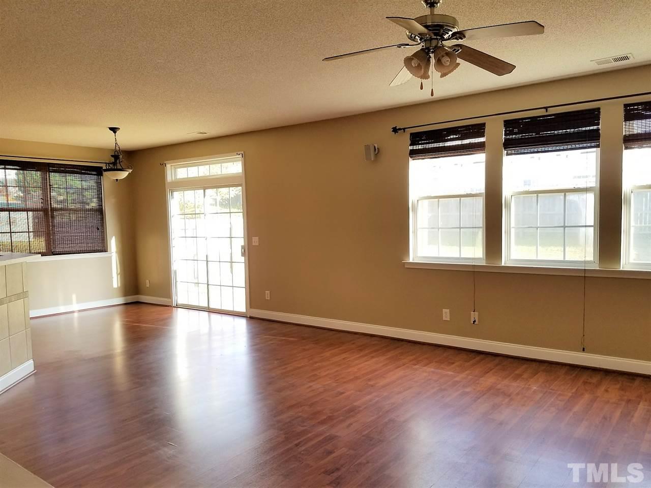 6044 Ricker Road Raleigh, NC 27610 - Photo 4 of 14 a view of an empty room with wooden floor and a window