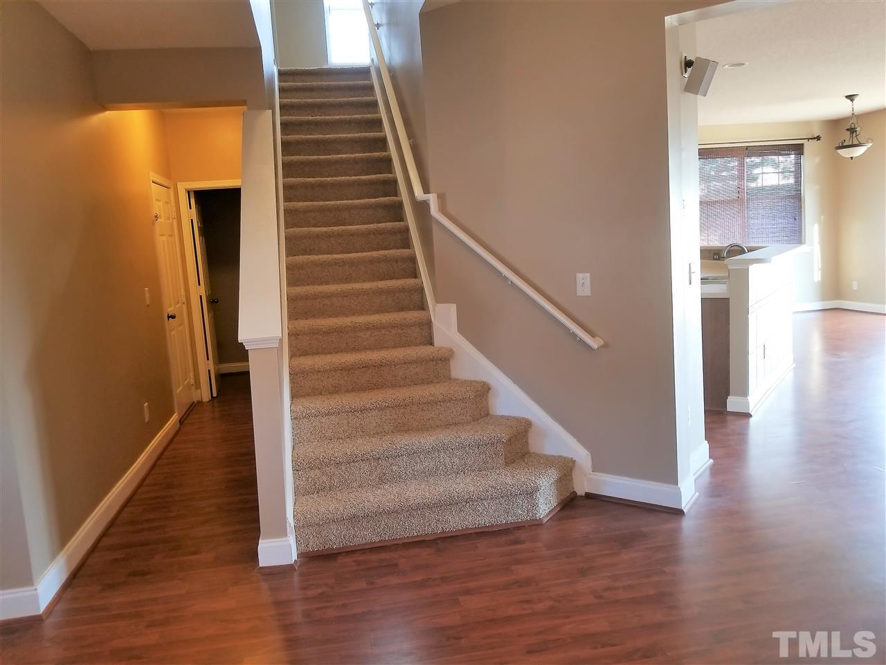 6044 Ricker Road Raleigh, NC 27610 - Photo 9 of 14 a view of entryway and hall with wooden floor