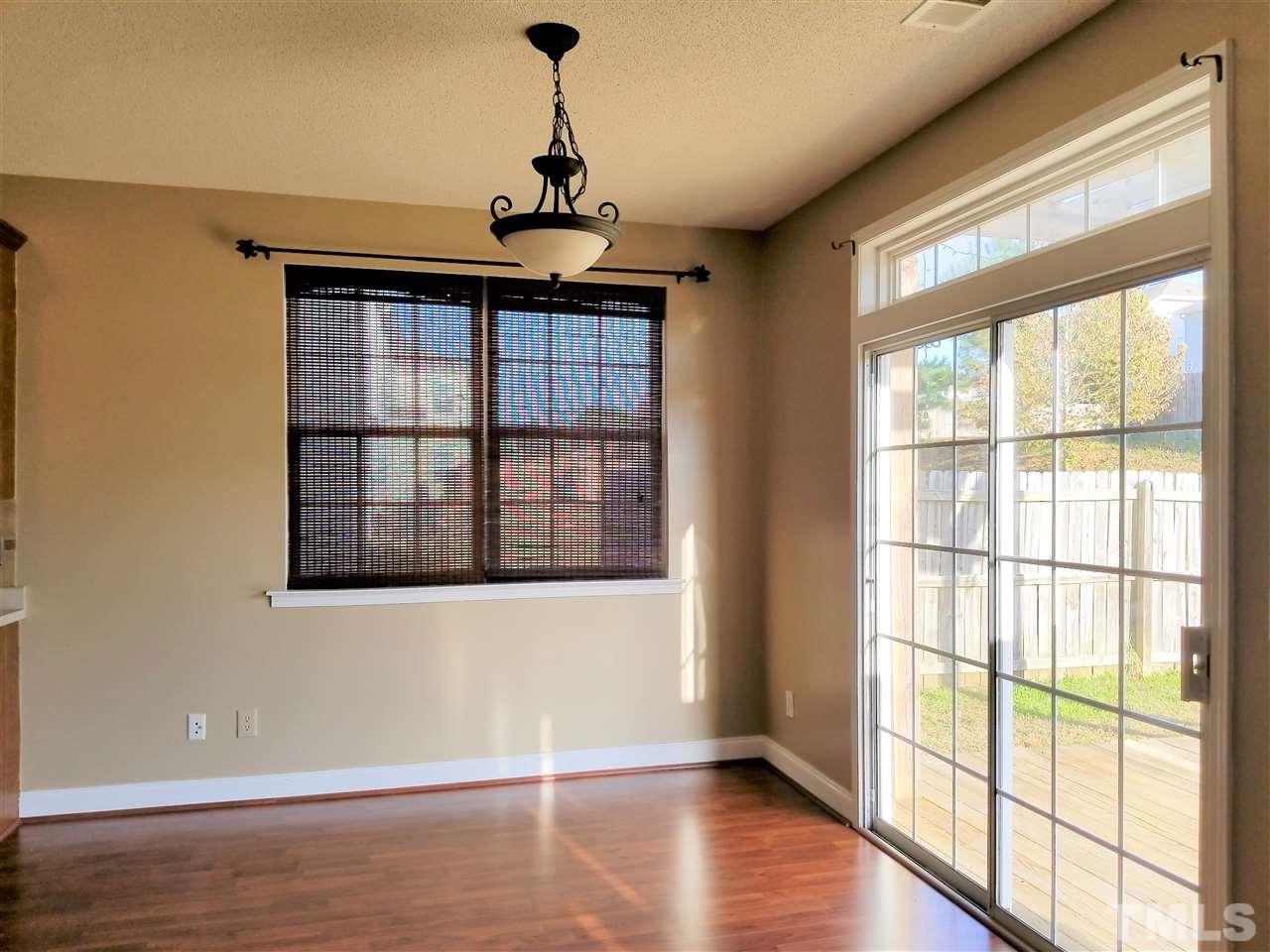 6044 Ricker Road Raleigh, NC 27610 - Photo 10 of 14 a view of an empty room with wooden floor and a window