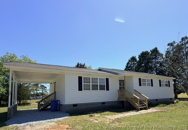 250 Trapper Run Lane Clinton, NC 28328 - Photo 2 of 22 a front view of a house with a yard