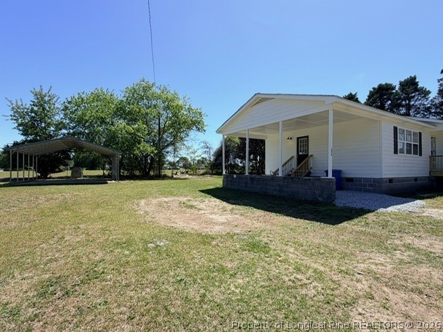 250 Trapper Run Lane Clinton, NC 28328 - Photo 3 of 22 a front view of house with yard and trees in the background