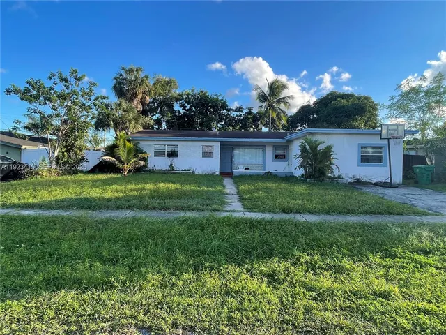 a view of a house with a yard and a garden