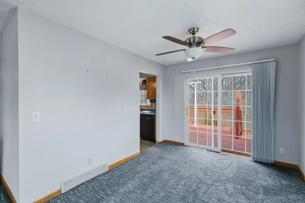 an empty room with closet and windows