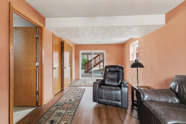 a view of a workspace with furniture and a window