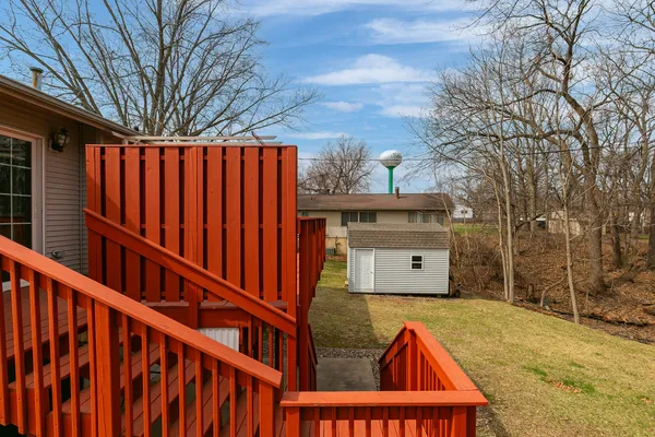 a view of a house with backyard and sitting area