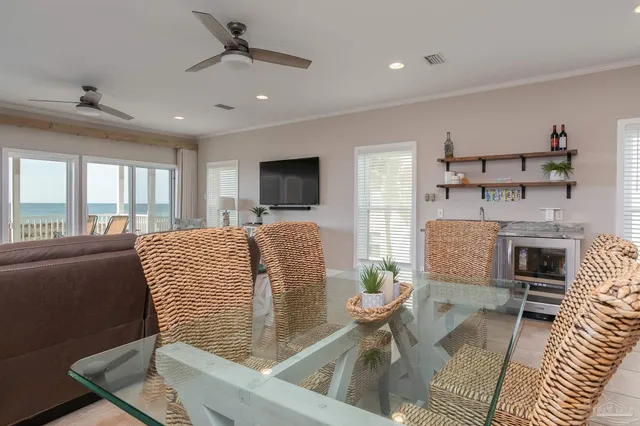 a kitchen with stainless steel appliances granite countertop a table chairs stove and refrigerator