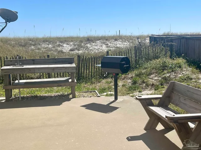 a view of a livingroom with furniture and floor to ceiling window