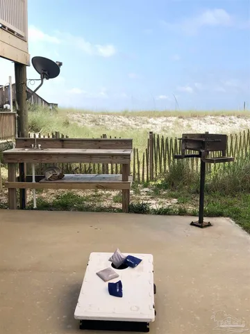 a large white building with a white roof and sitting space