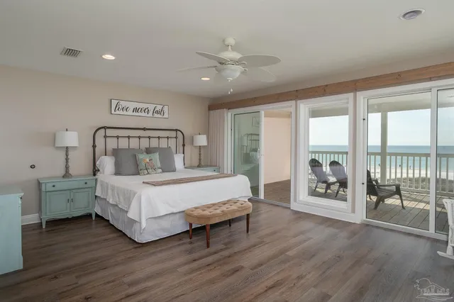a living room with furniture and floor to ceiling windows