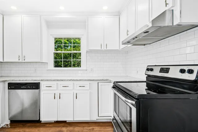 a kitchen with granite countertop a stove and a sink