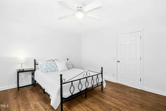 a bedroom with a bed and a ceiling fan