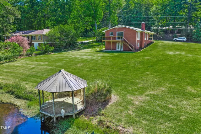 a aerial view of a house with backyard and pool