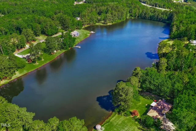 an aerial view of a house with a yard basket ball court and outdoor seating