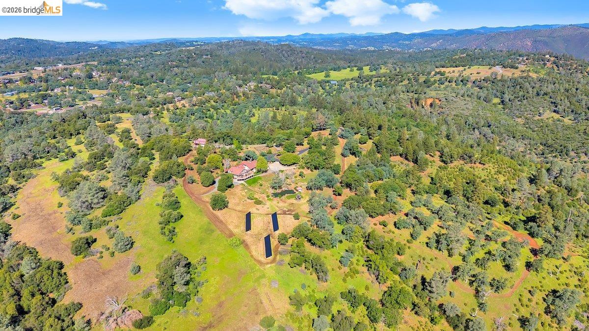 13700 Clements Road Groveland, CA 95321 - Photo 84 of 93 Sprawling property featuring extensive acreage with rolling hills, abundant mature trees, and a visible residential structure