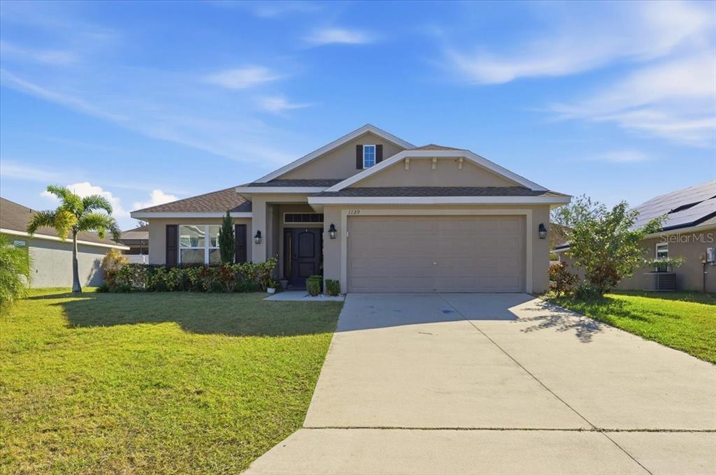 a front view of a house with garden