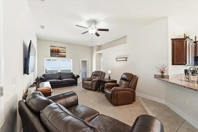 a bathroom with a granite countertop sink a toilet and a mirror