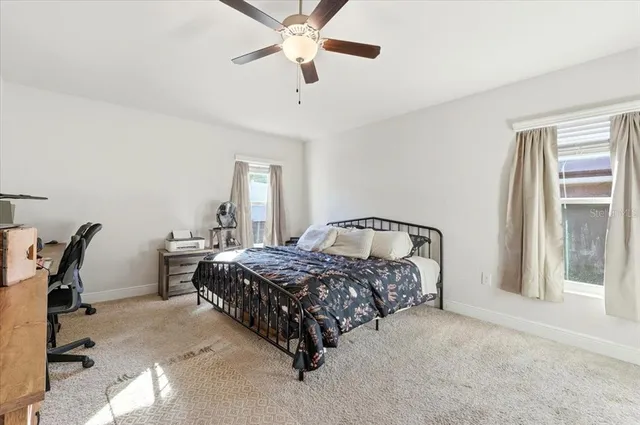 a bedroom with a bed and a tv