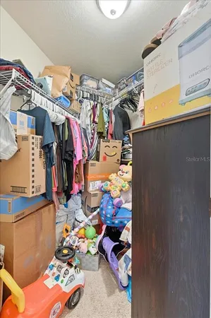 a view of walk in closet with clothes