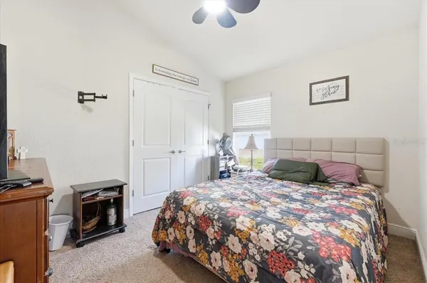 a bedroom with a bed and a tv