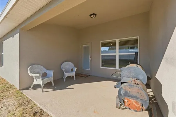 a bedroom with a bed and a window with chair