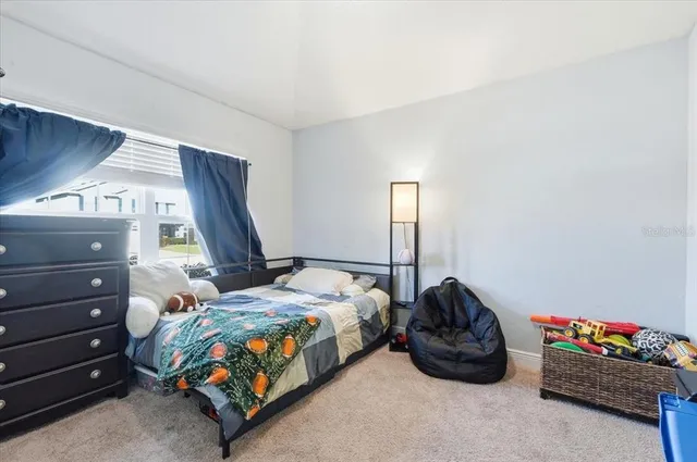a kitchen with granite countertop a sink a stove and refrigerator