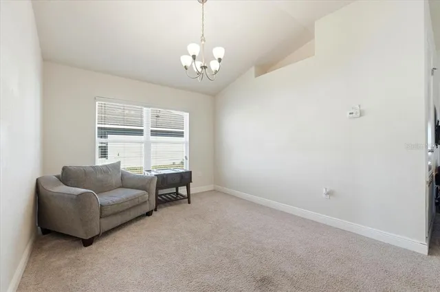 a large kitchen with a large counter top a sink stainless steel appliances and cabinets