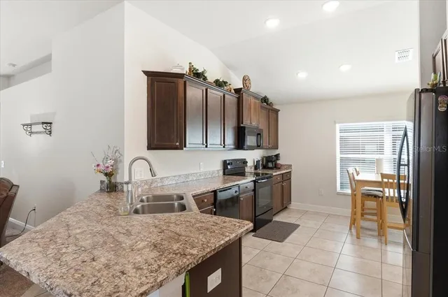 a kitchen with cabinets a sink and appliances